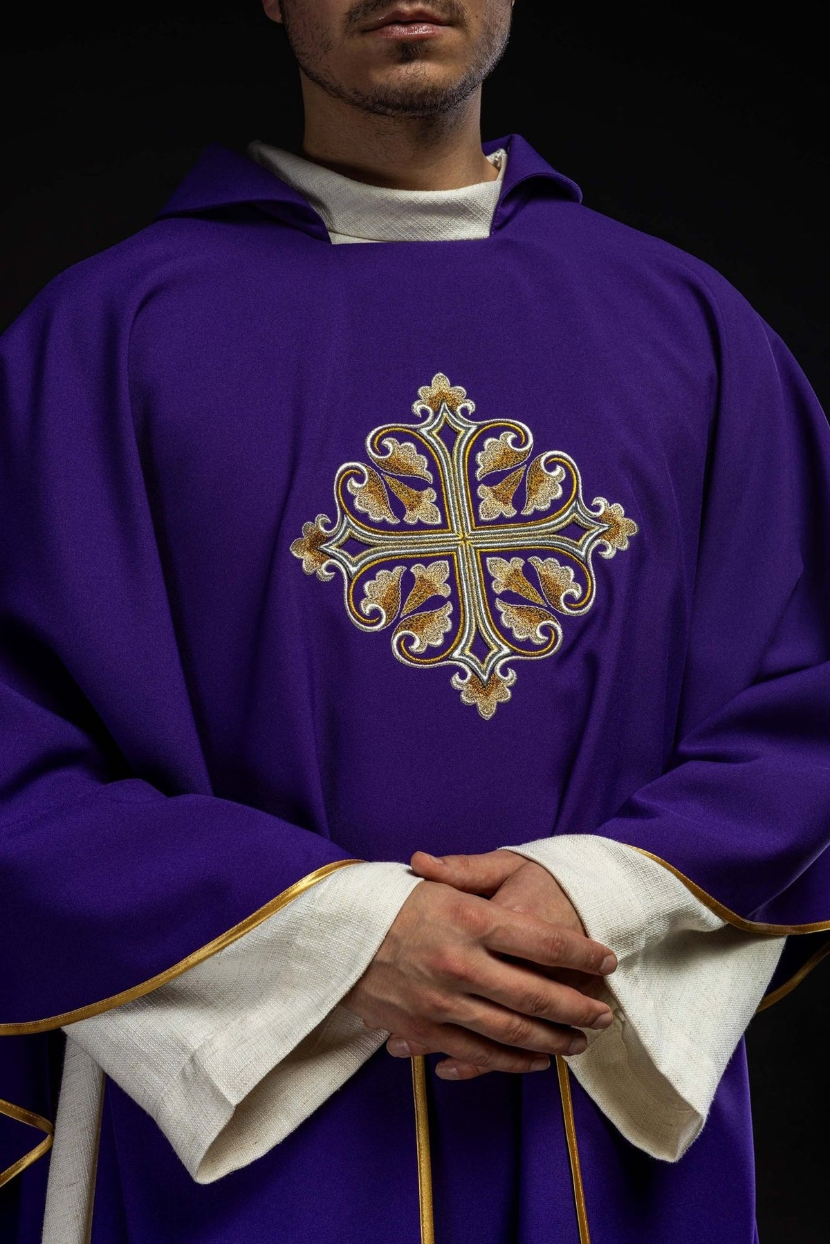 Purple chasuble front close-up showing embroidered gold cross and wide square collar