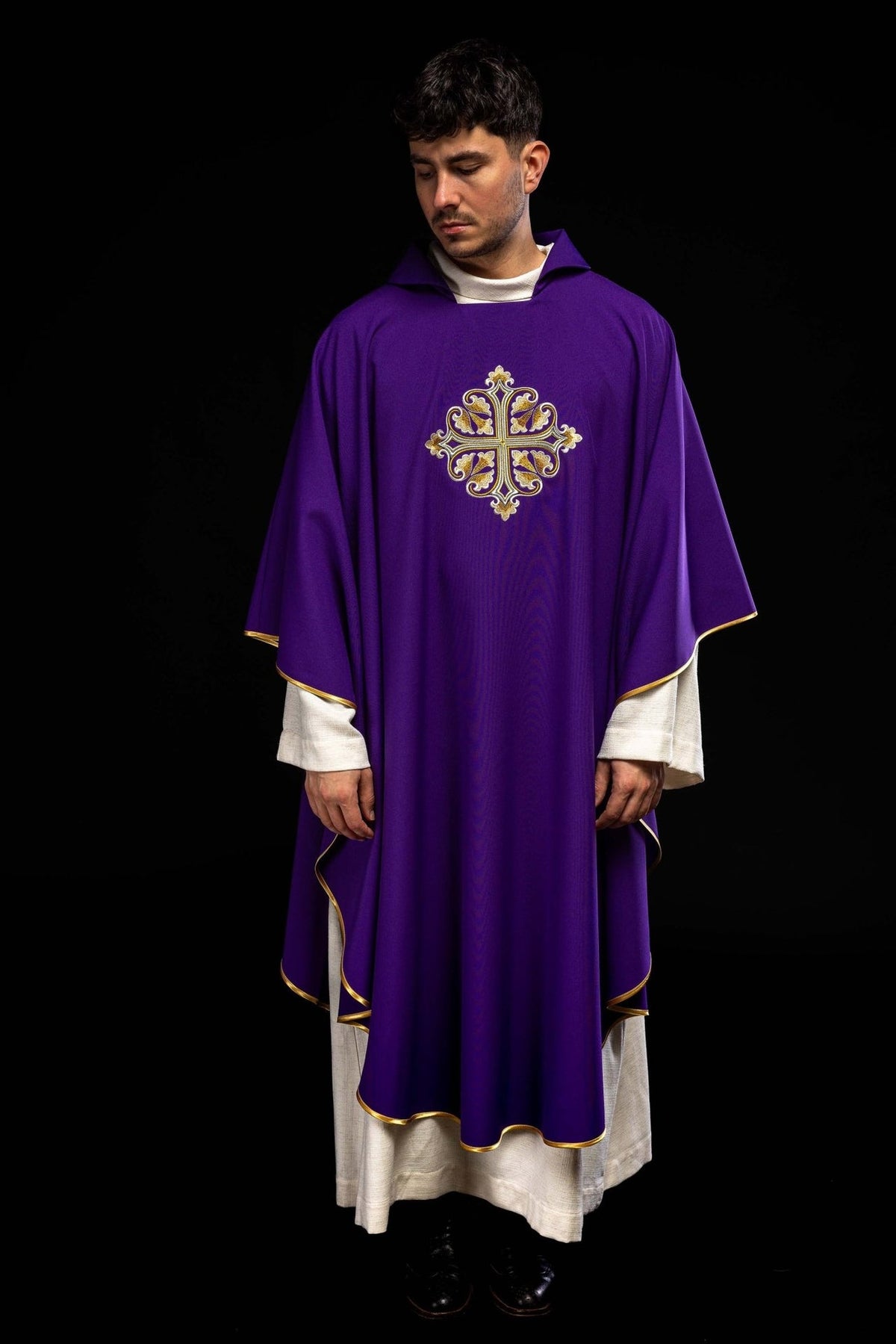 Purple chasuble full front view with embroidered cross and gold-trimmed edges