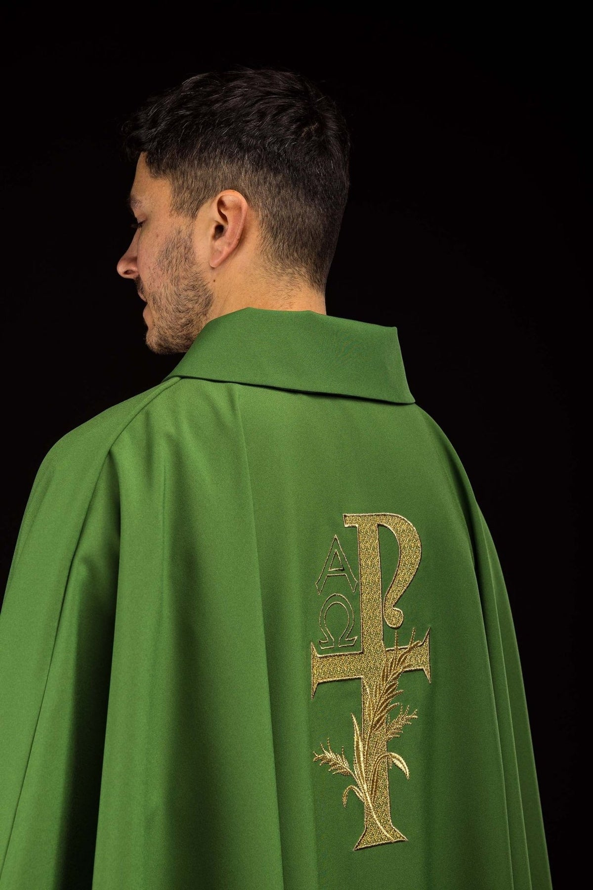 Green chasuble back view with gold Alpha Omega embroidery