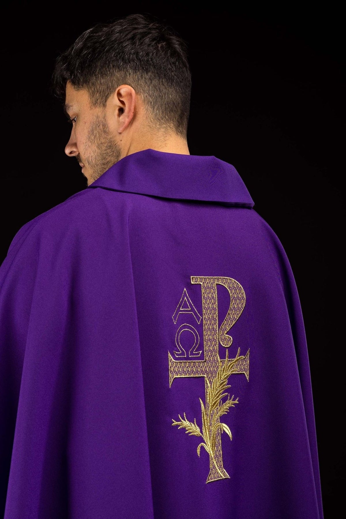 Purple chasuble back view with gold Alpha Omega embroidery and wide collar