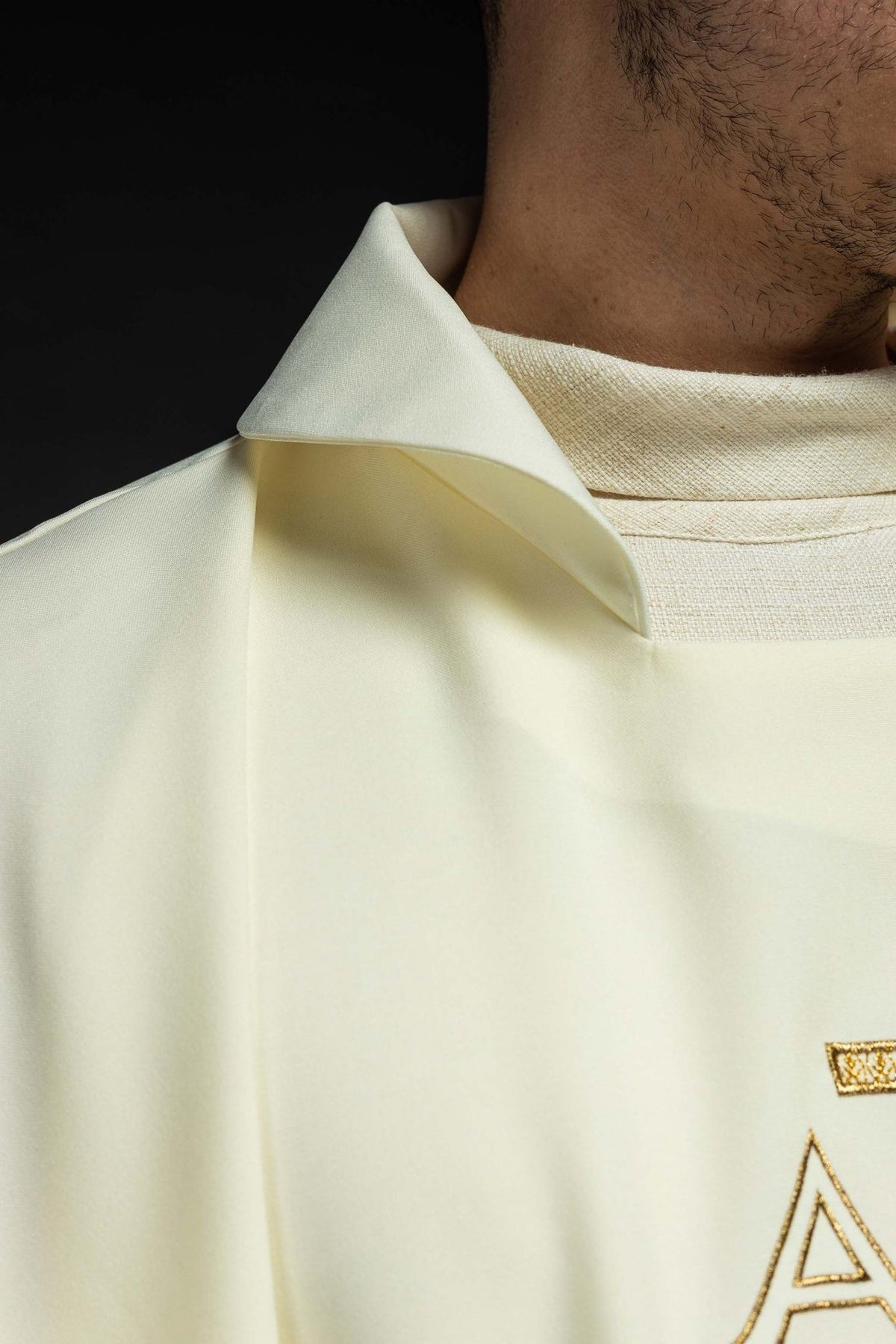Embroidered chasuble close-up showing the wide ecru collar