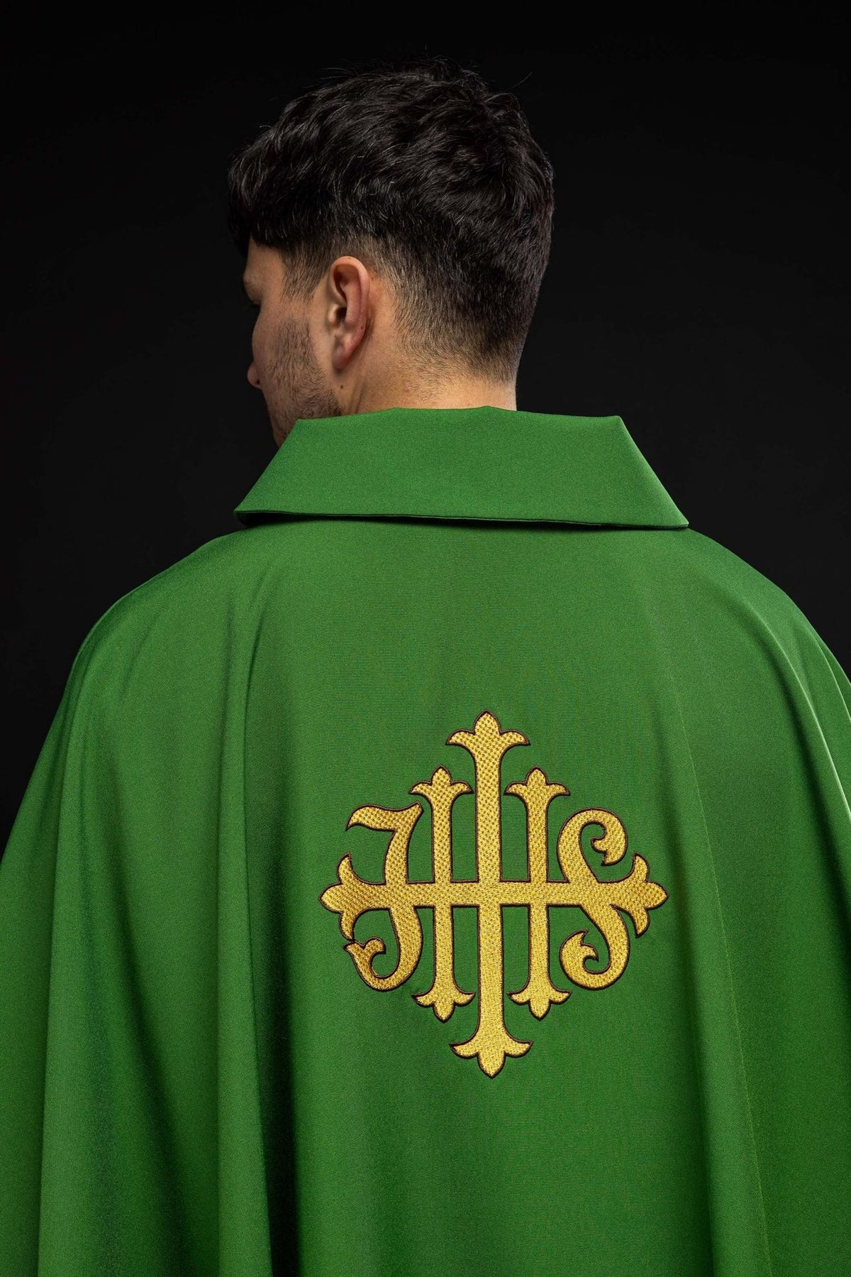 Green chasuble back view with gold JHS embroidery and wide collar