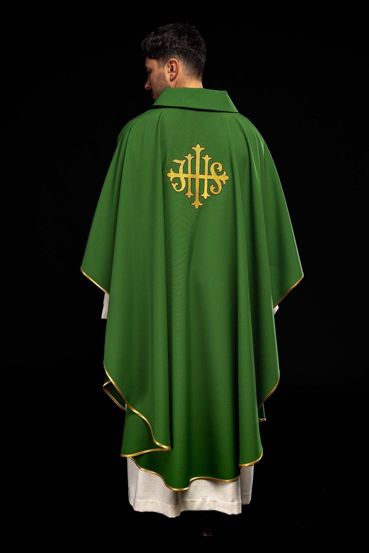 Green chasuble back view with gold trim and embroidered JHS symbol