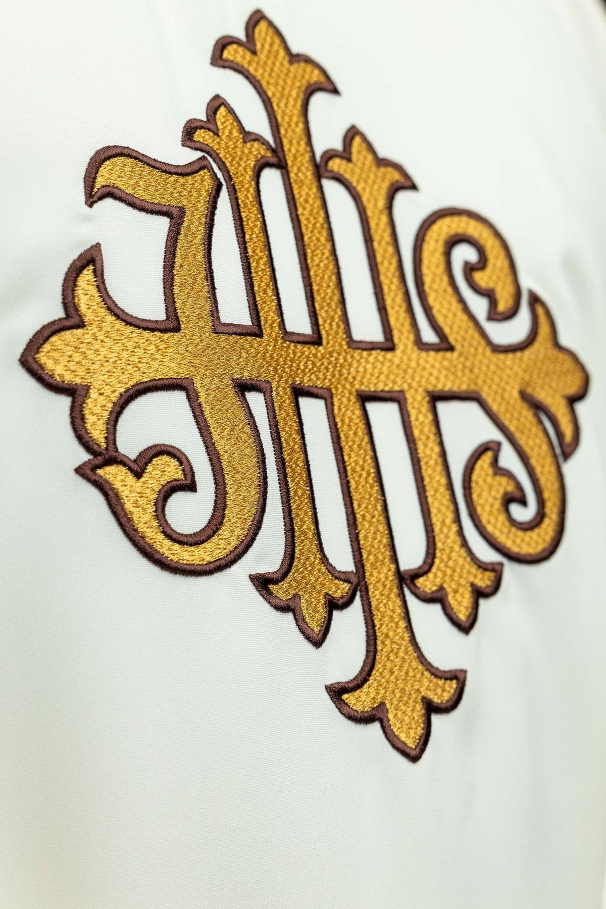 Ecru chasuble close-up of gold JHS embroidery on the front