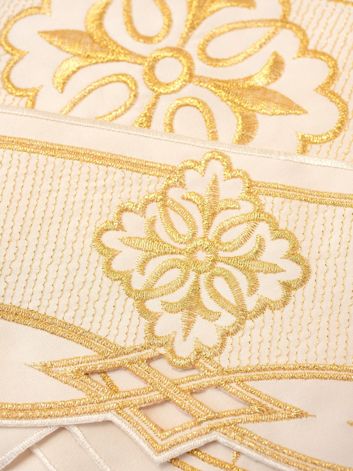 Altar lace close-up showing gold Rozeta embroidery and geometric border