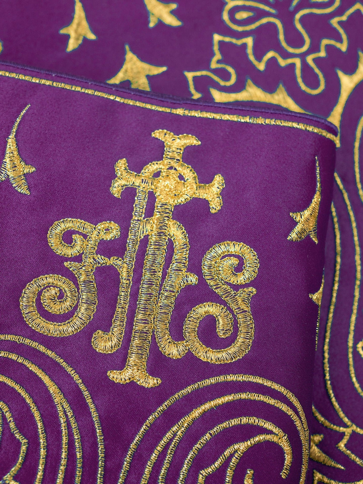 Purple altar lace close-up showing gold IHS embroidery and ornate motifs