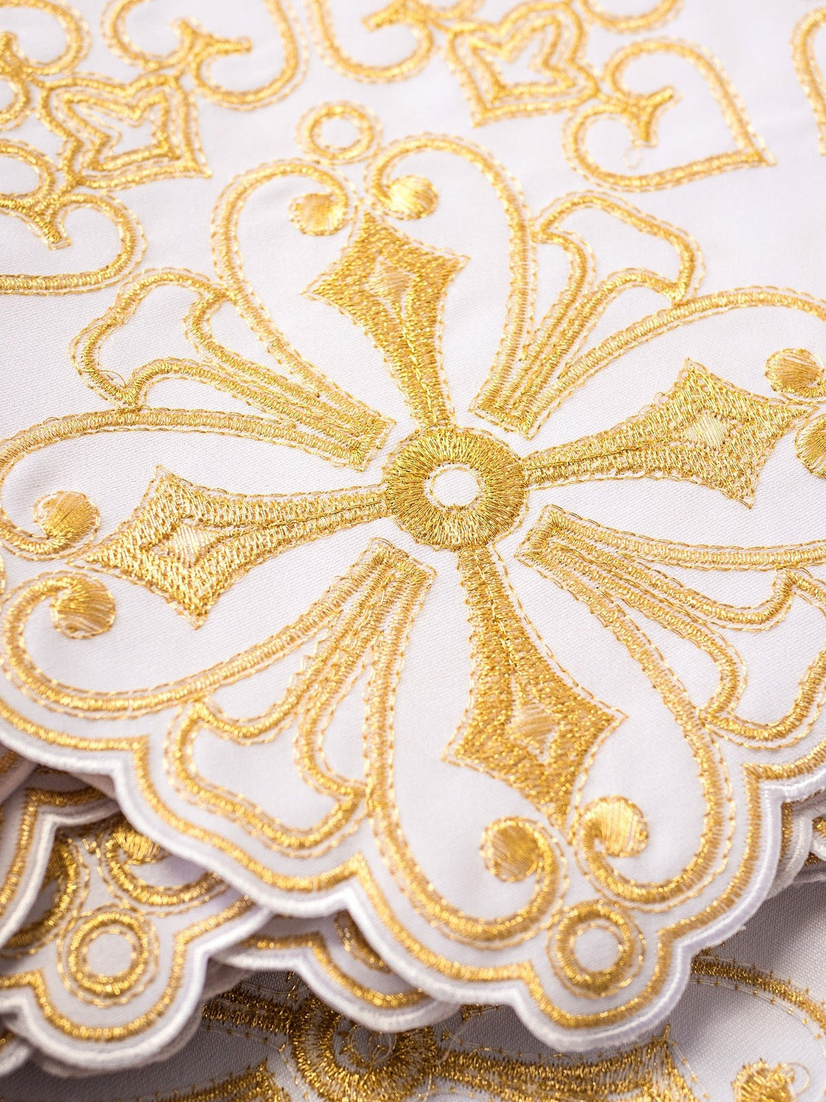 Altar lace close-up showing white fabric and detailed gold Rozeta embroidery