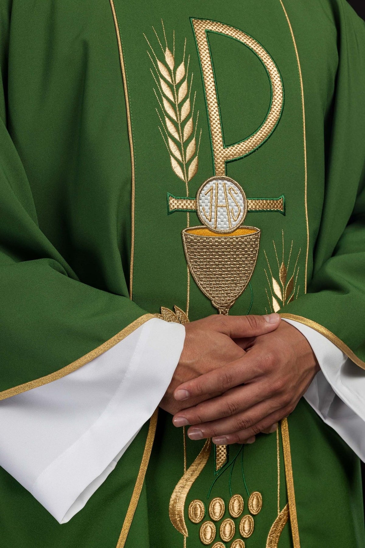 Green chasuble close-up showing embroidered chalice and gold orphrey details