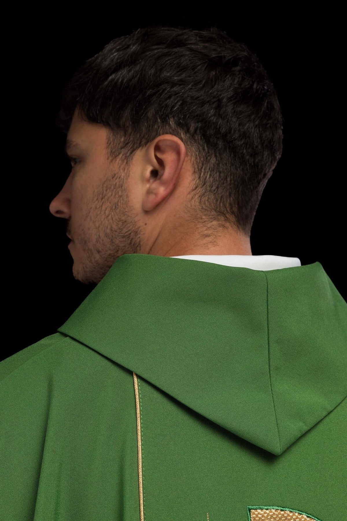 Fabric label and gold trim detail belonging to the green chasuble