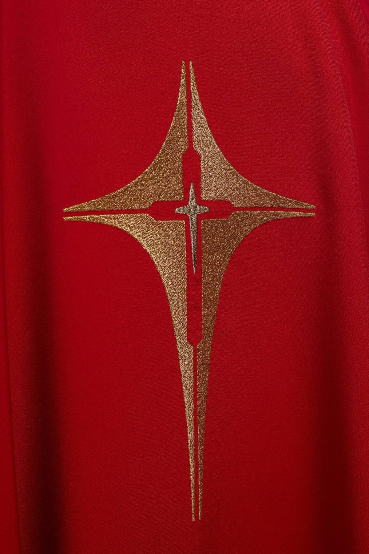 Red chasuble close-up with large gold embroidered cross motif