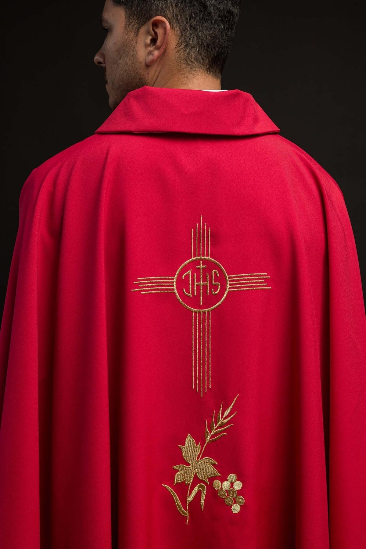 Red chasuble back view with gold IHS and floral embroidery
