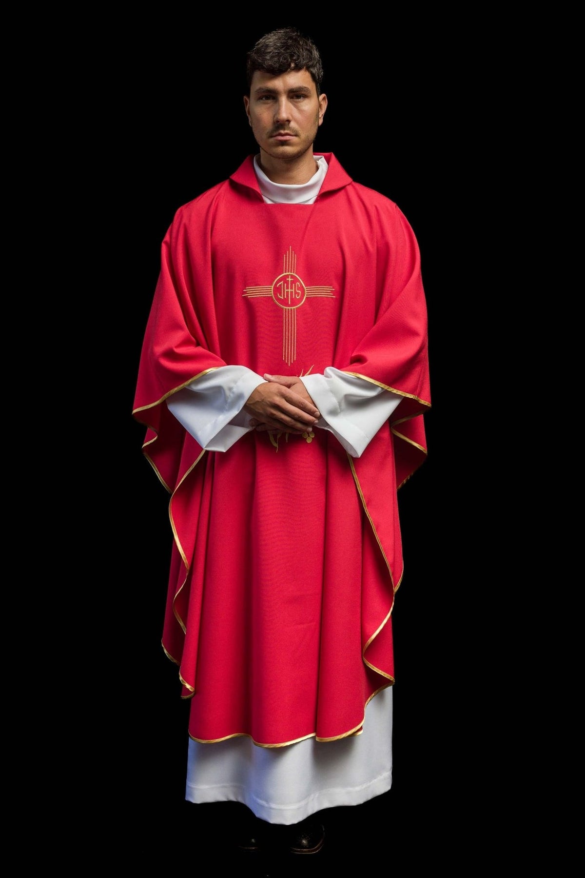 Red chasuble worn front view with wide collar, gold IHS embroidery and trim