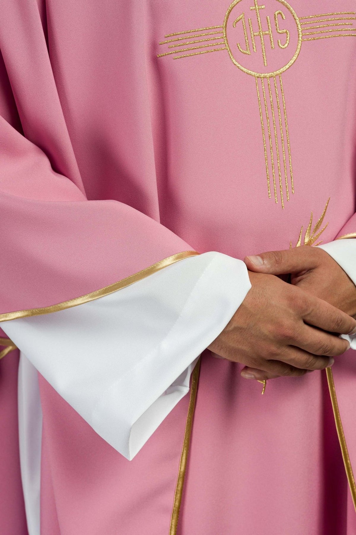 Rose chasuble detail showing gold trim on the sleeve and white undergarment