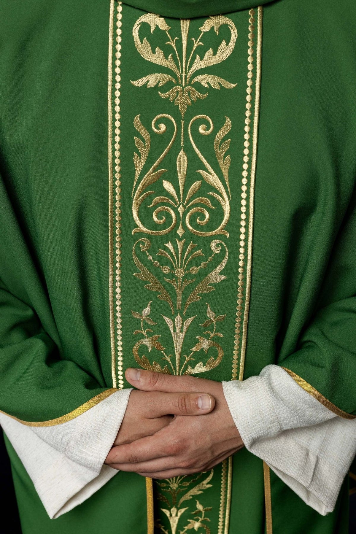 Green chasuble close-up showing gold embroidered floral orphrey