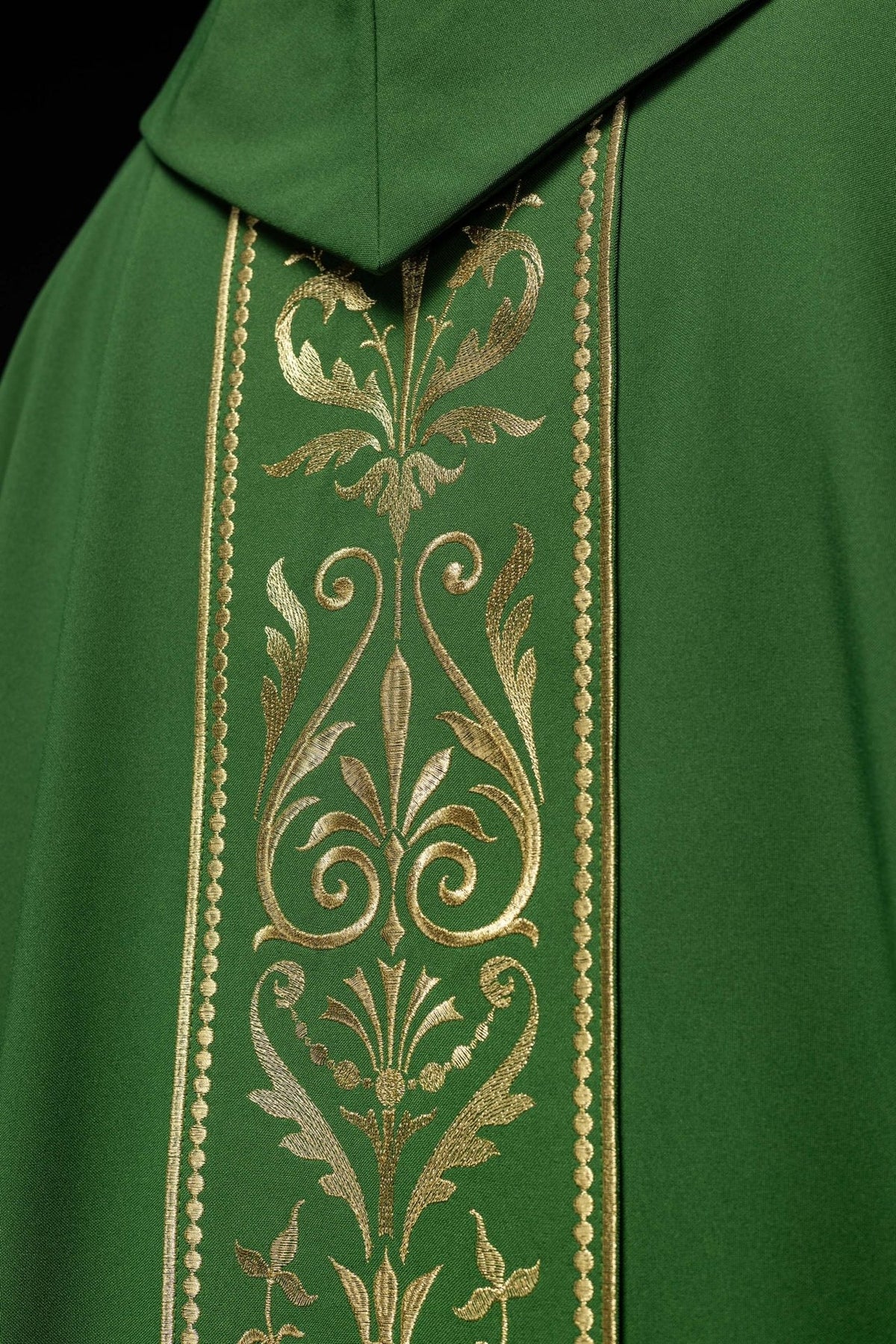 Green chasuble close-up of gold floral embroidery and orphrey trim