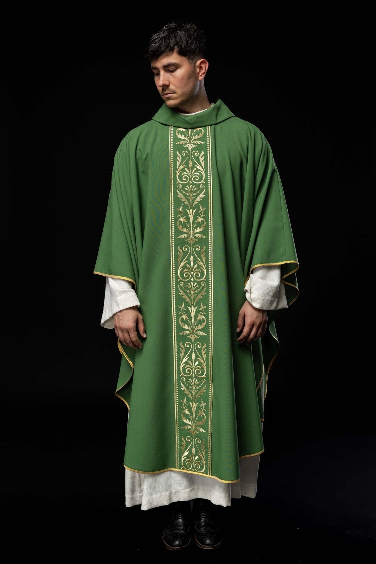 Green chasuble front view showing full-length gold embroidered orphrey