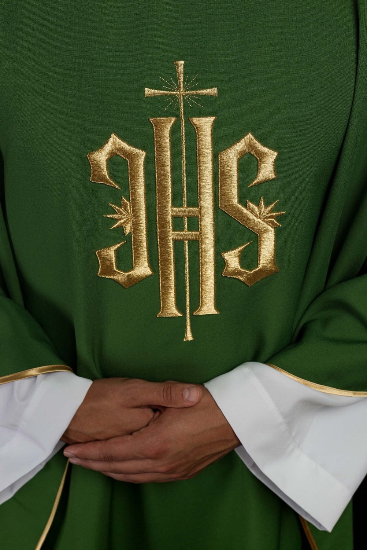 Green chasuble close-up showing gold IHS embroidery and cross