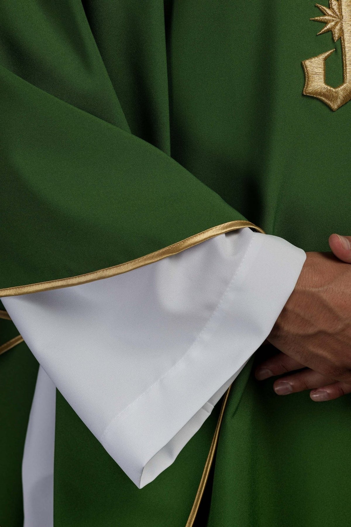 Green chasuble detail showing gold trim on the sleeve edge