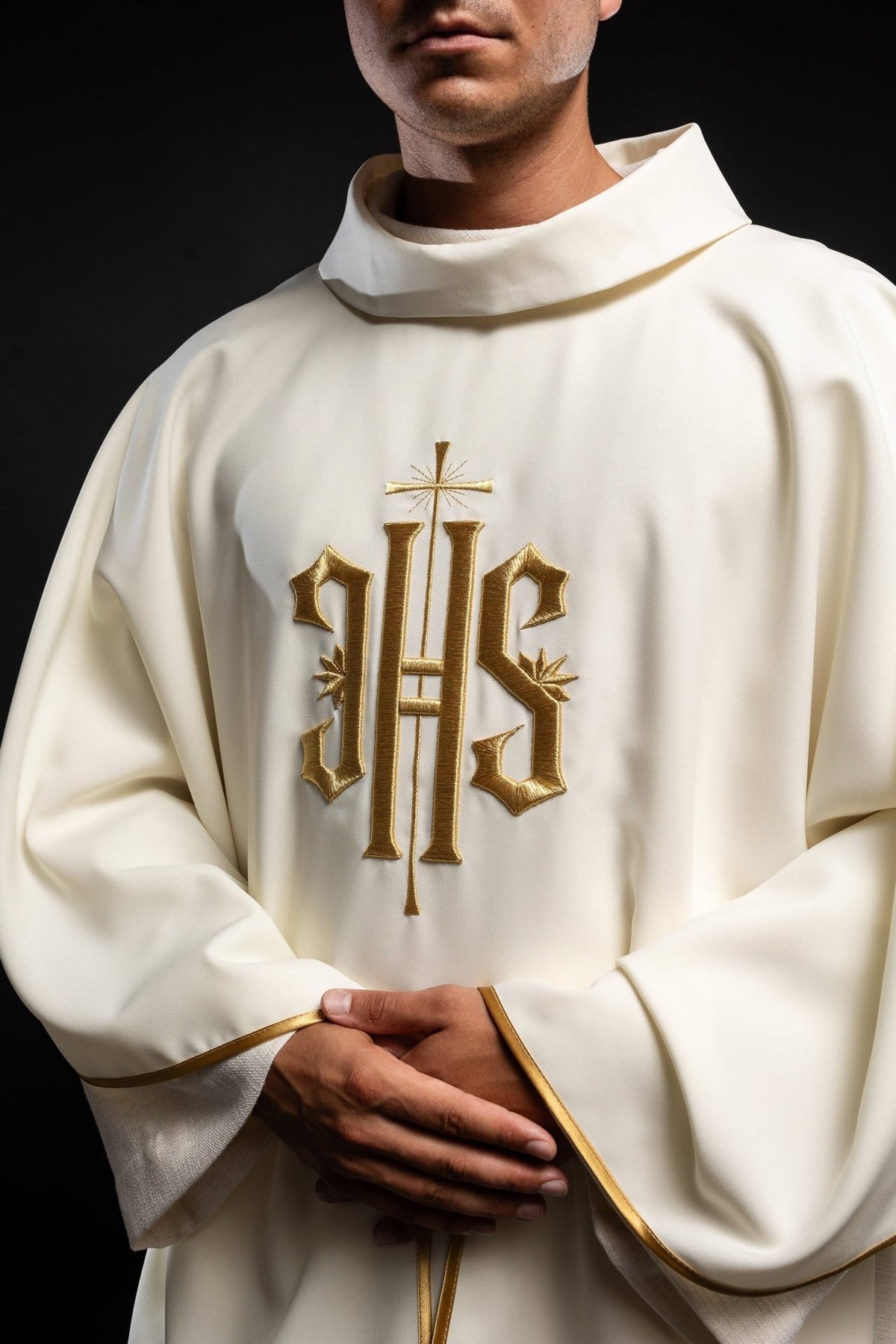 Ecru chasuble front close-up with gold IHS embroidery and gold trim on sleeves