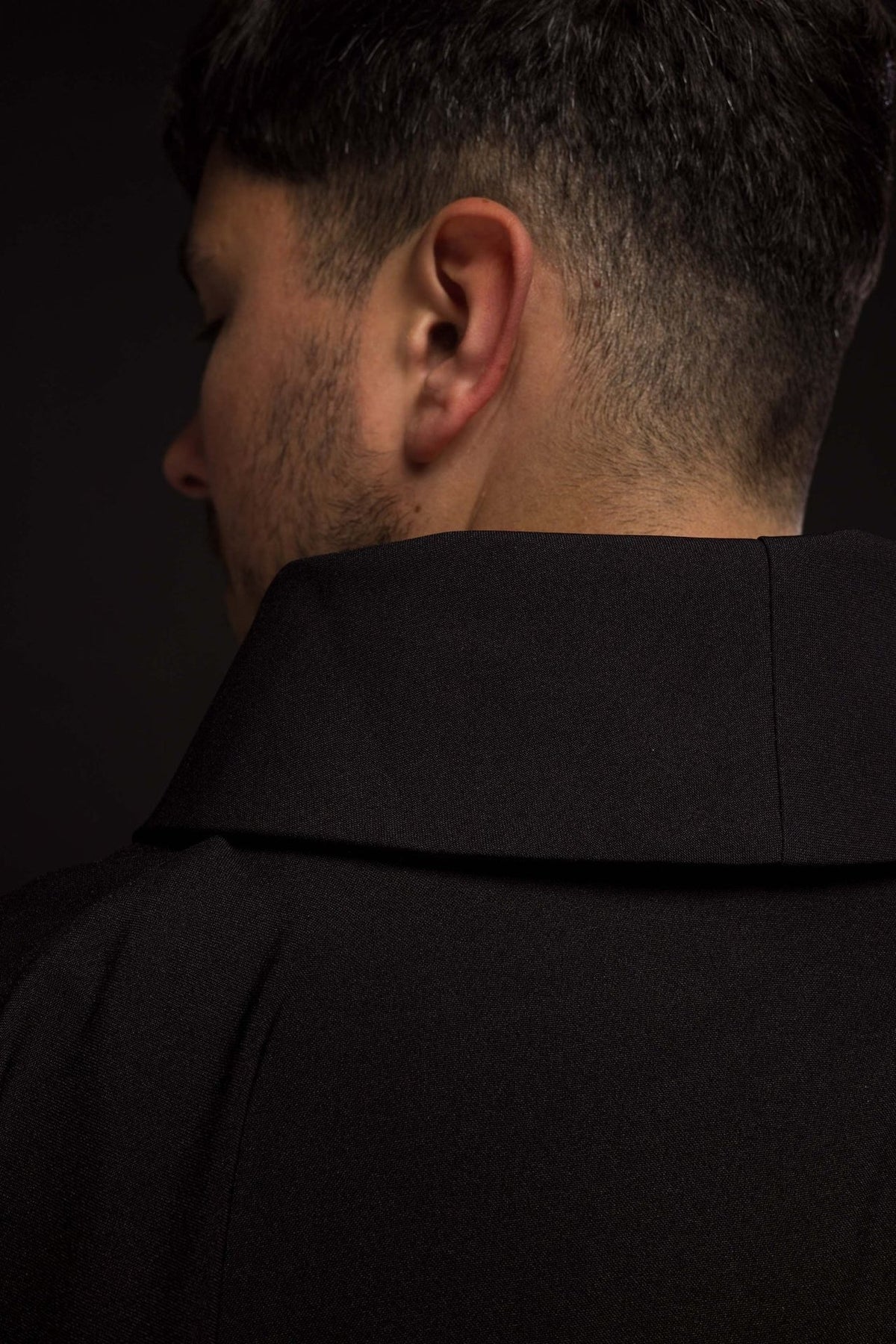 Black chasuble close-up of stand-up collar and back seam
