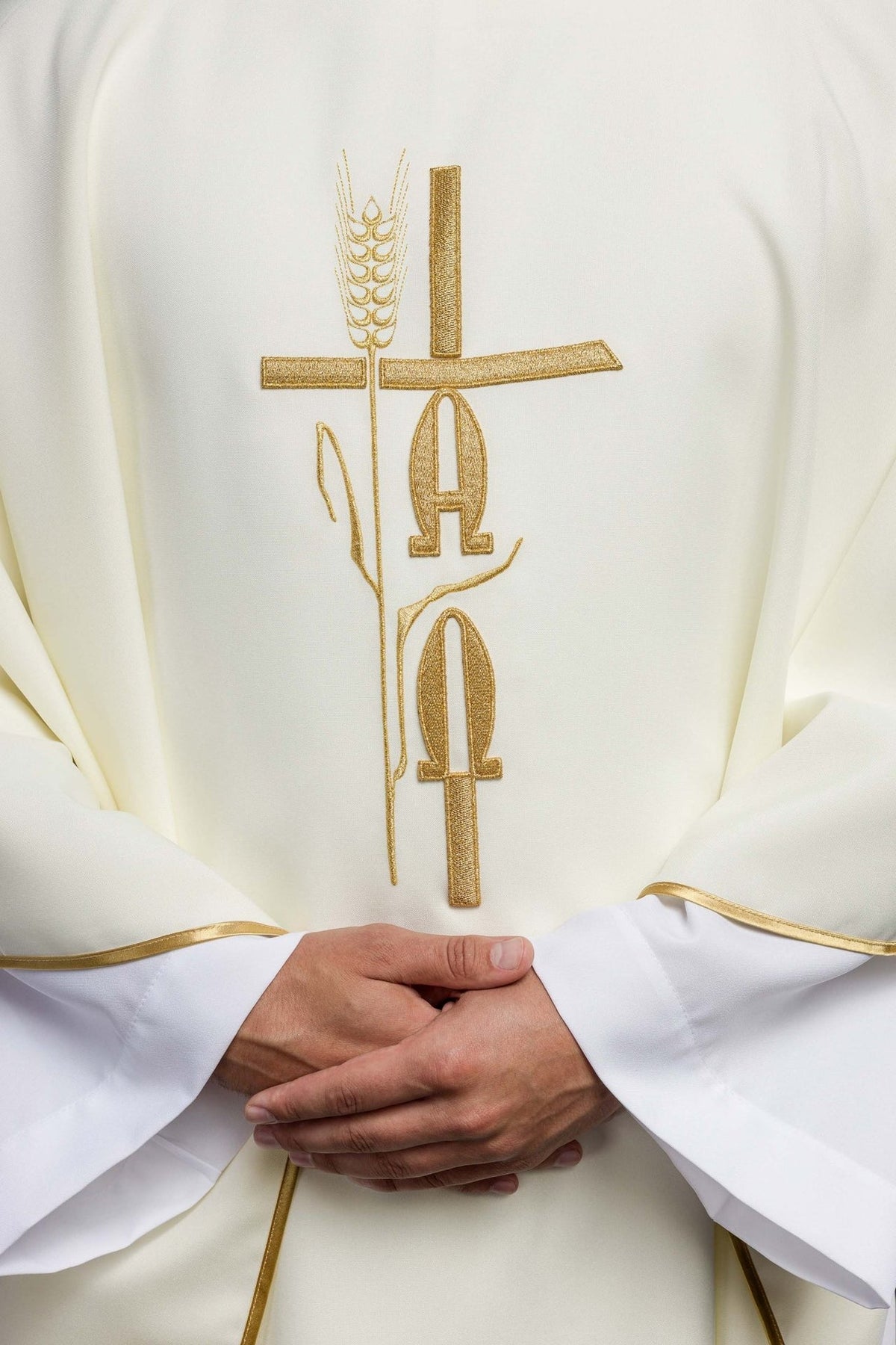 Ecru chasuble front close-up showing gold Alpha, Omega and cross embroidery