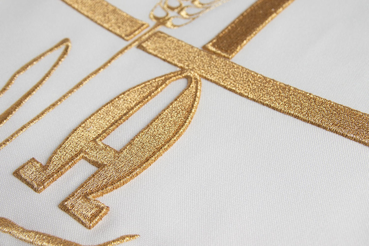 Ecru chasuble embroidery close-up with gold Alpha, Omega and cross motifs