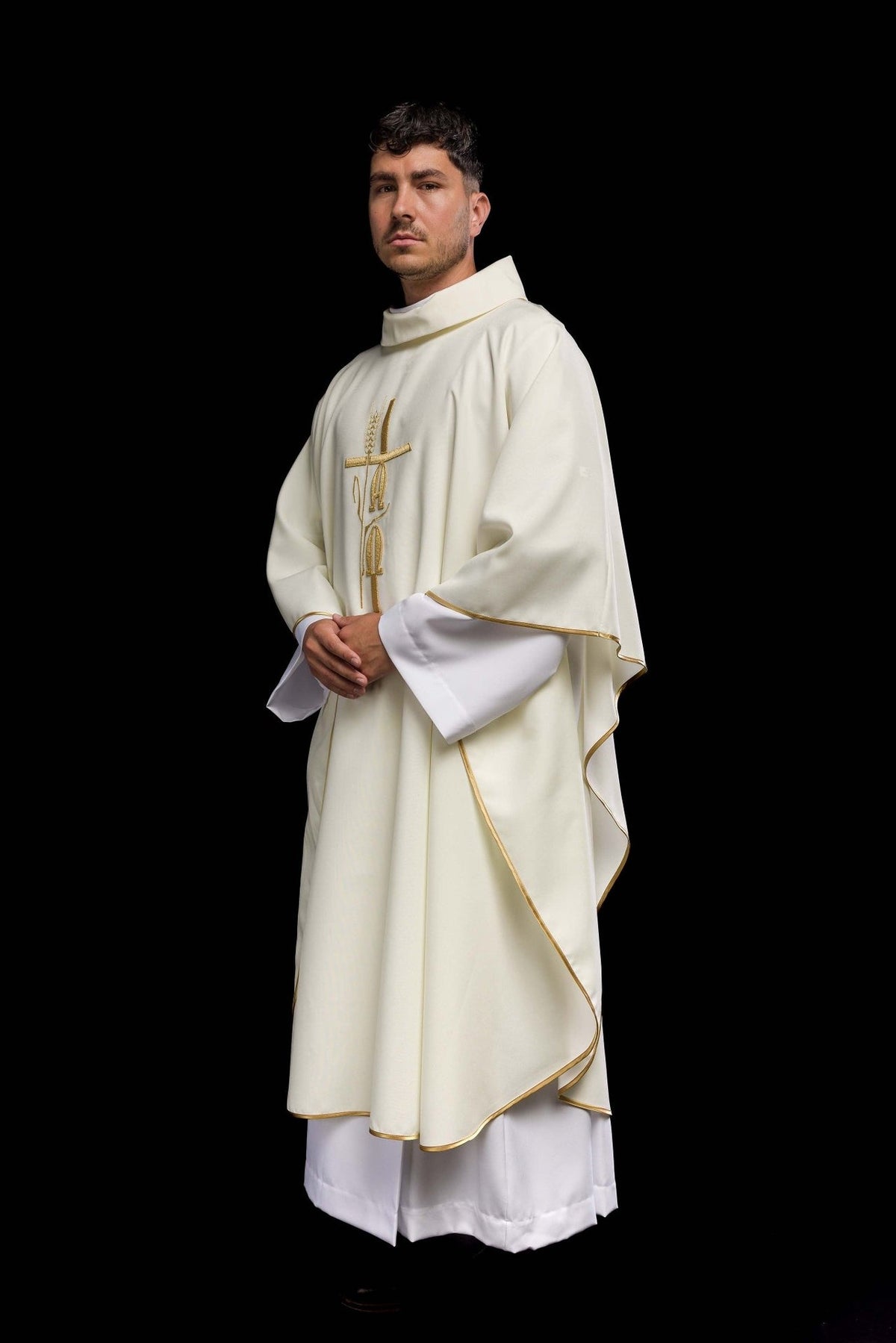 Ecru chasuble side view with gold trim and stand-up collar