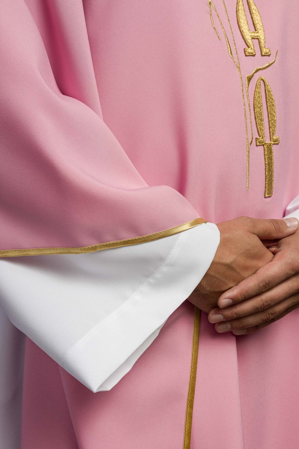 Pink chasuble detail showing gold trim and rose embroidery