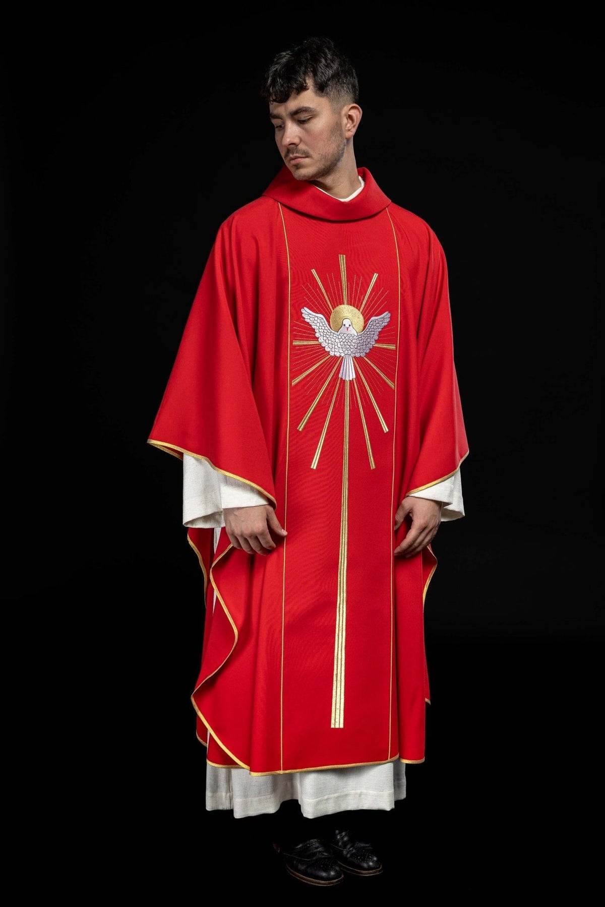 Red chasuble front worn view with Holy Spirit embroidery and gold trim