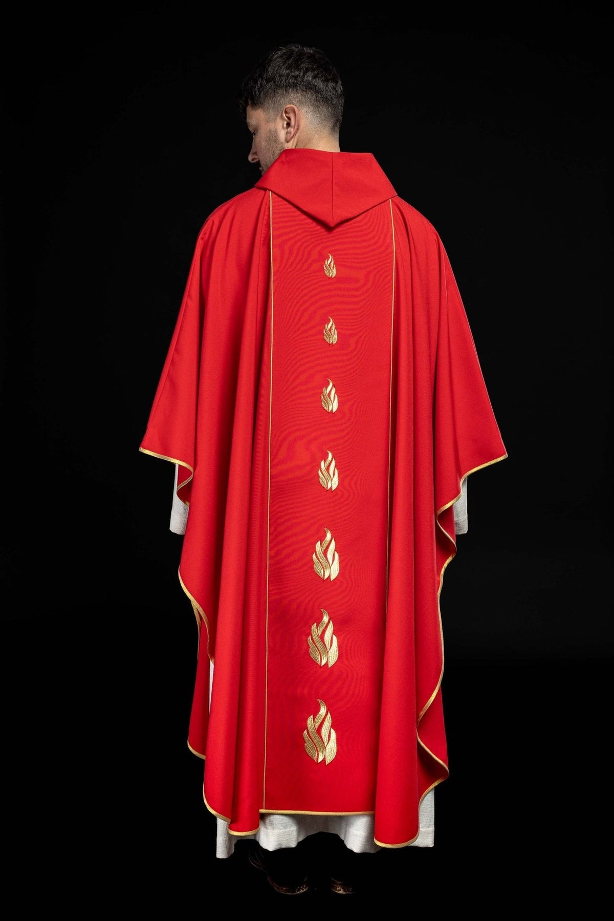 Red chasuble back worn view with embroidered gold tongues of fire