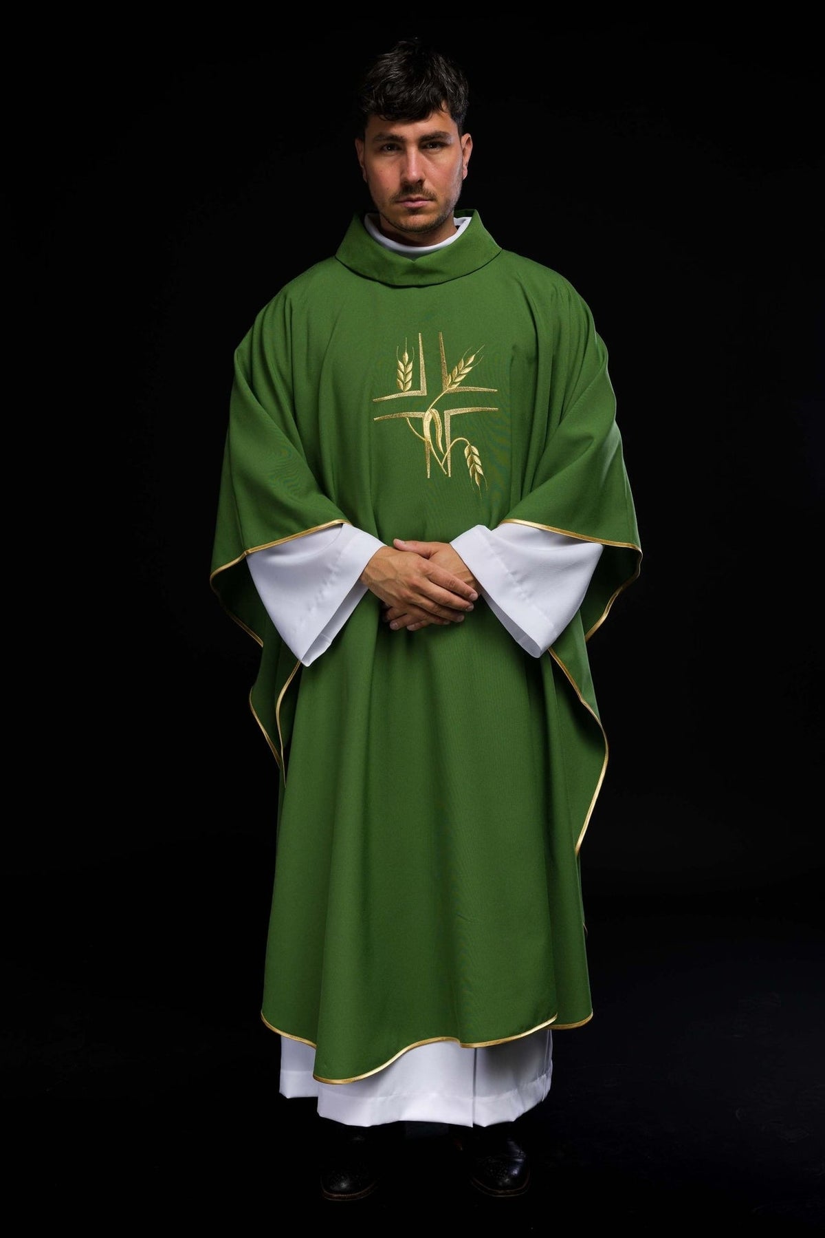 Green chasuble worn full length, showing gold cross and wheat embroidery