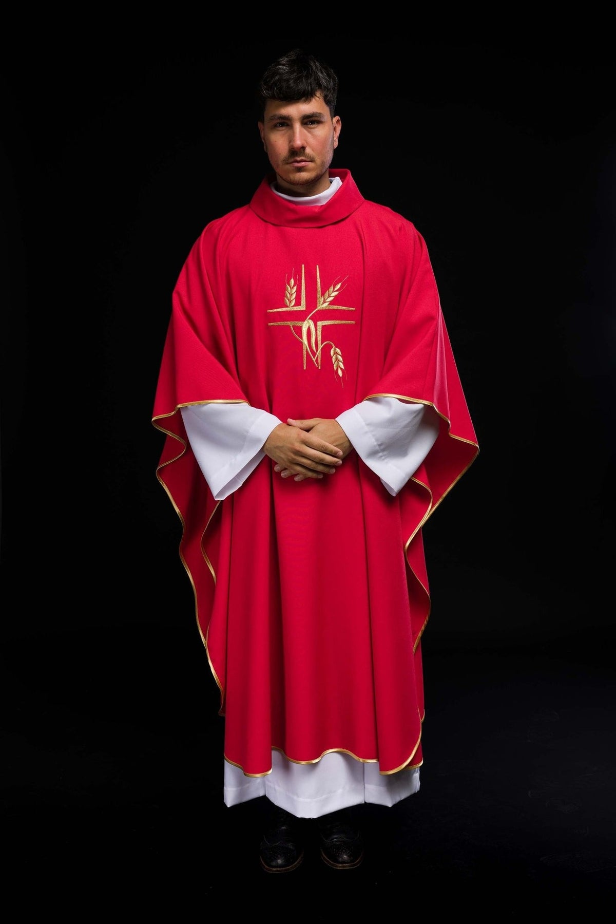 Red chasuble worn in full front view with gold cross and wheat embroidery