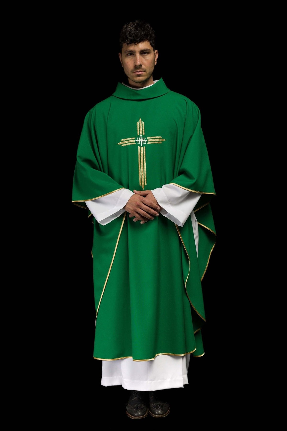 Green chasuble worn in full front view with gold IHS cross embroidery