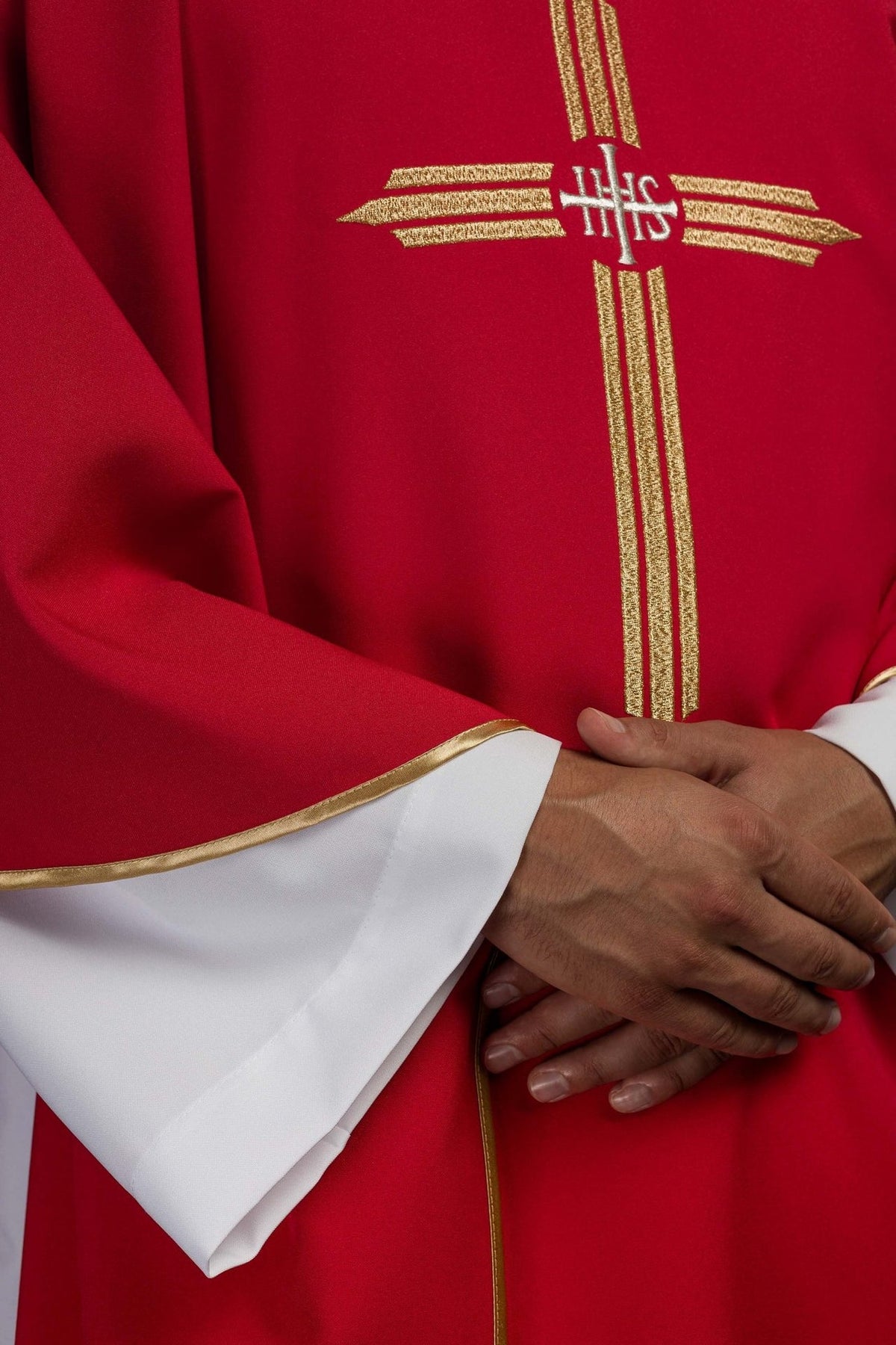 Red chasuble detail showing gold IHS cross embroidery and trim