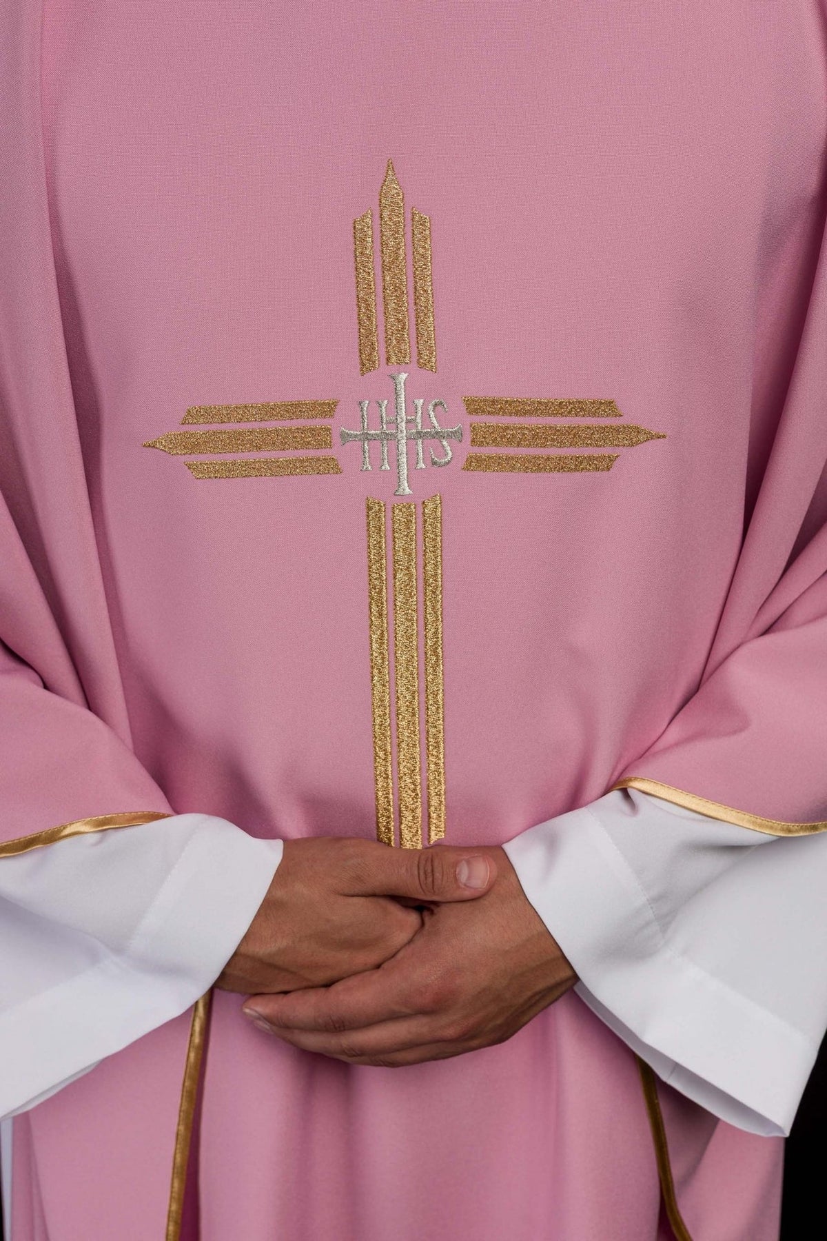 Rose chasuble, close-up of gold IHS cross embroidery on the front