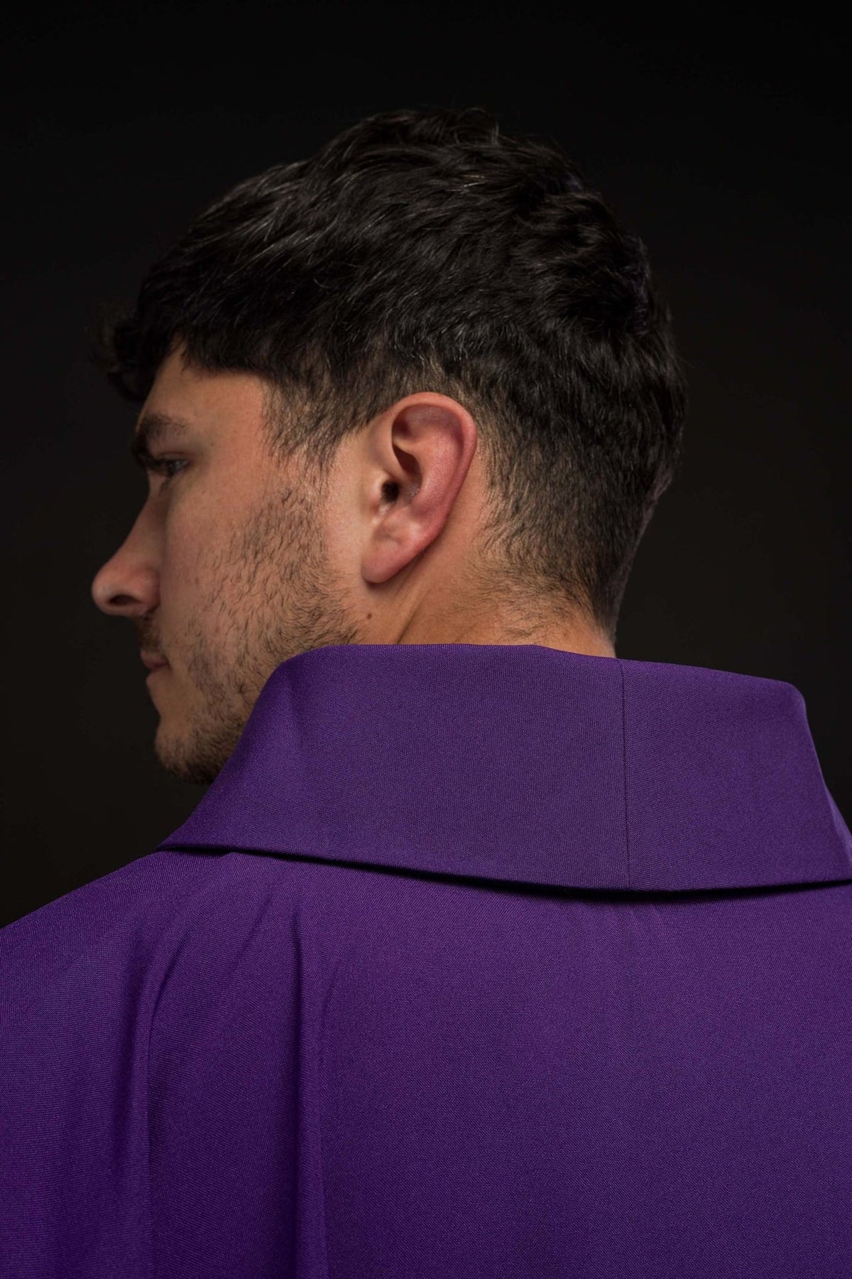Purple chasuble side view showing gold trim and gold PAX embroidery
