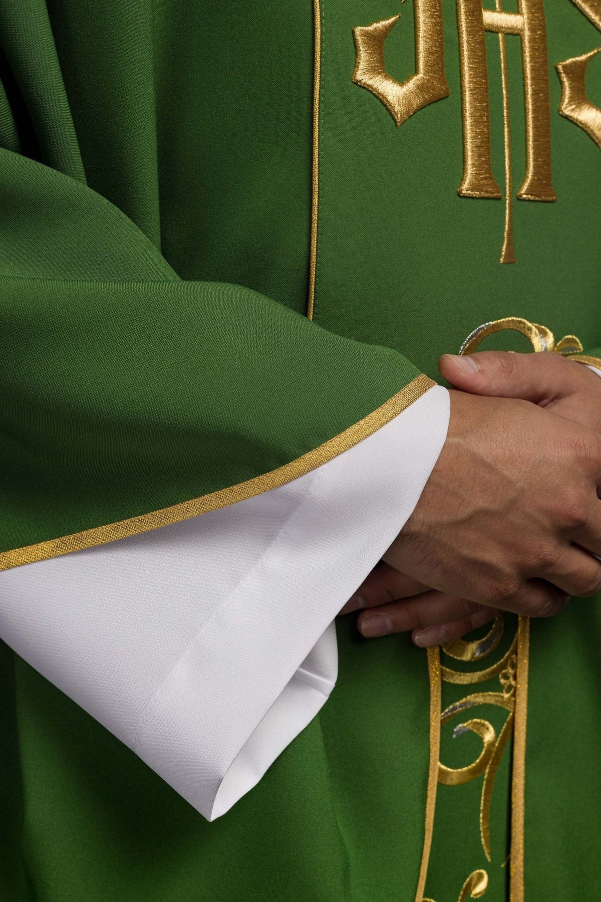 Green chasuble detail showing gold trim and sleeve edge