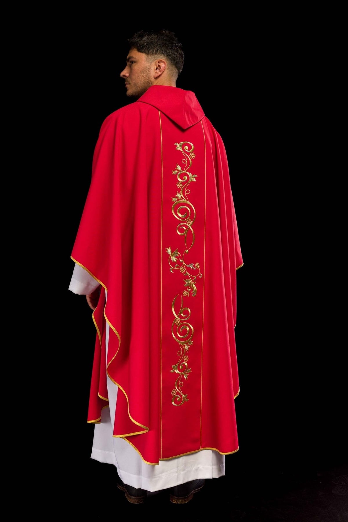 Red chasuble back detail with gold embroidered floral scrollwork