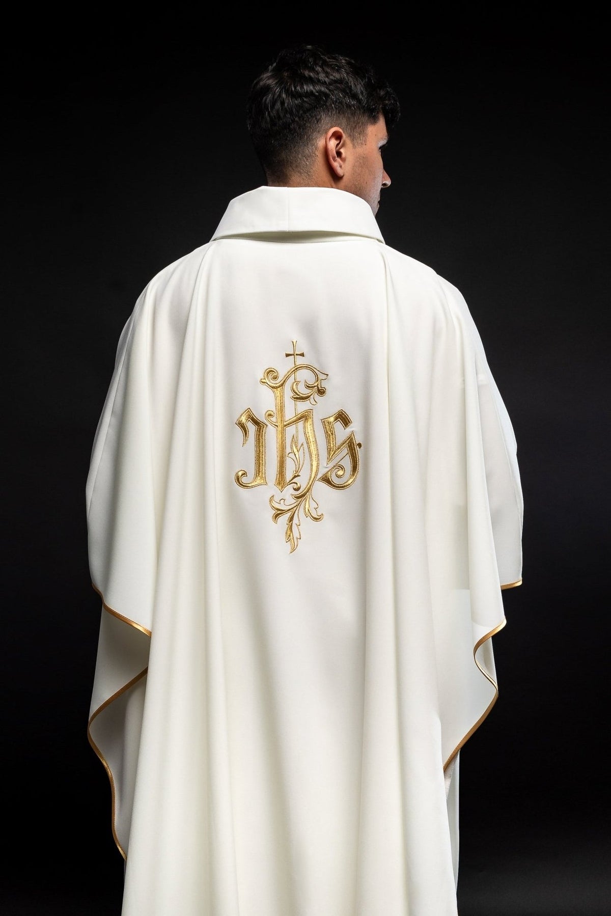 Cream chasuble back view with gold IHS embroidery and gold trim