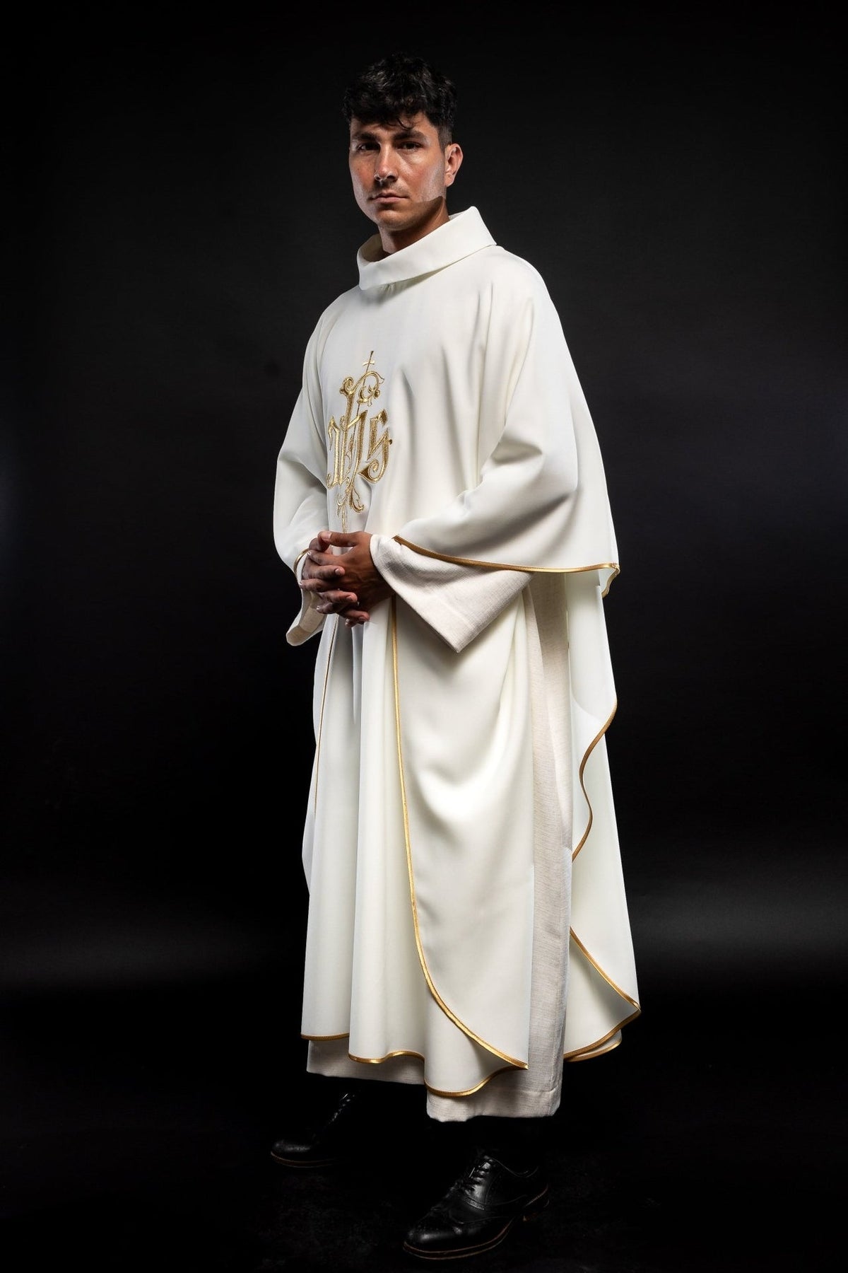 Cream chasuble side view showing flowing shape, stand-up collar and gold trim