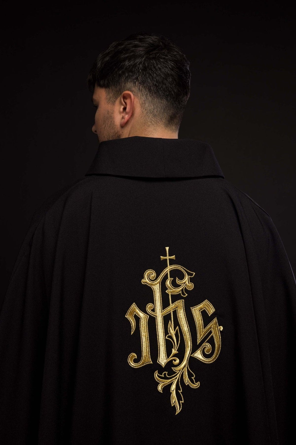 Black IHS chasuble close-up of gold embroidered IHS motif