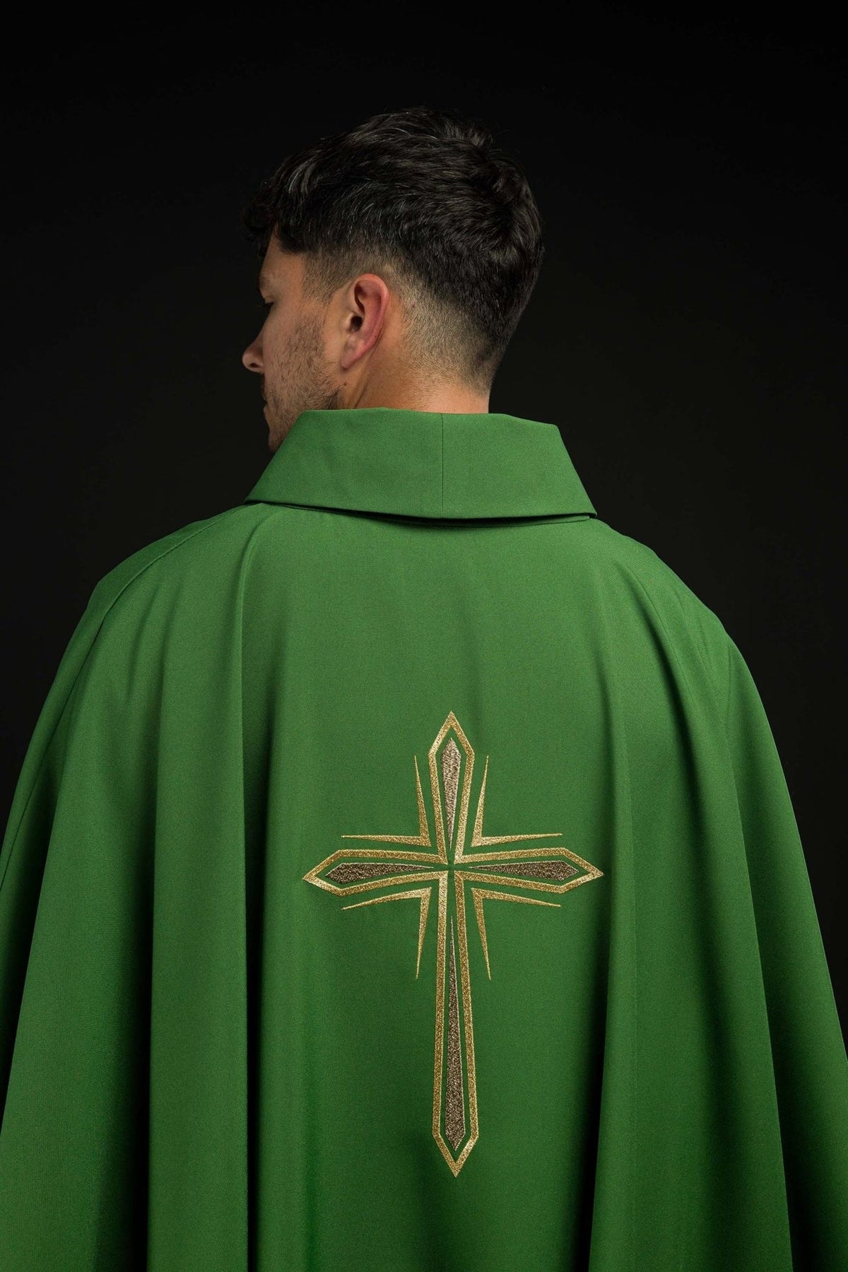 Green chasuble back view with large gold embroidered cross