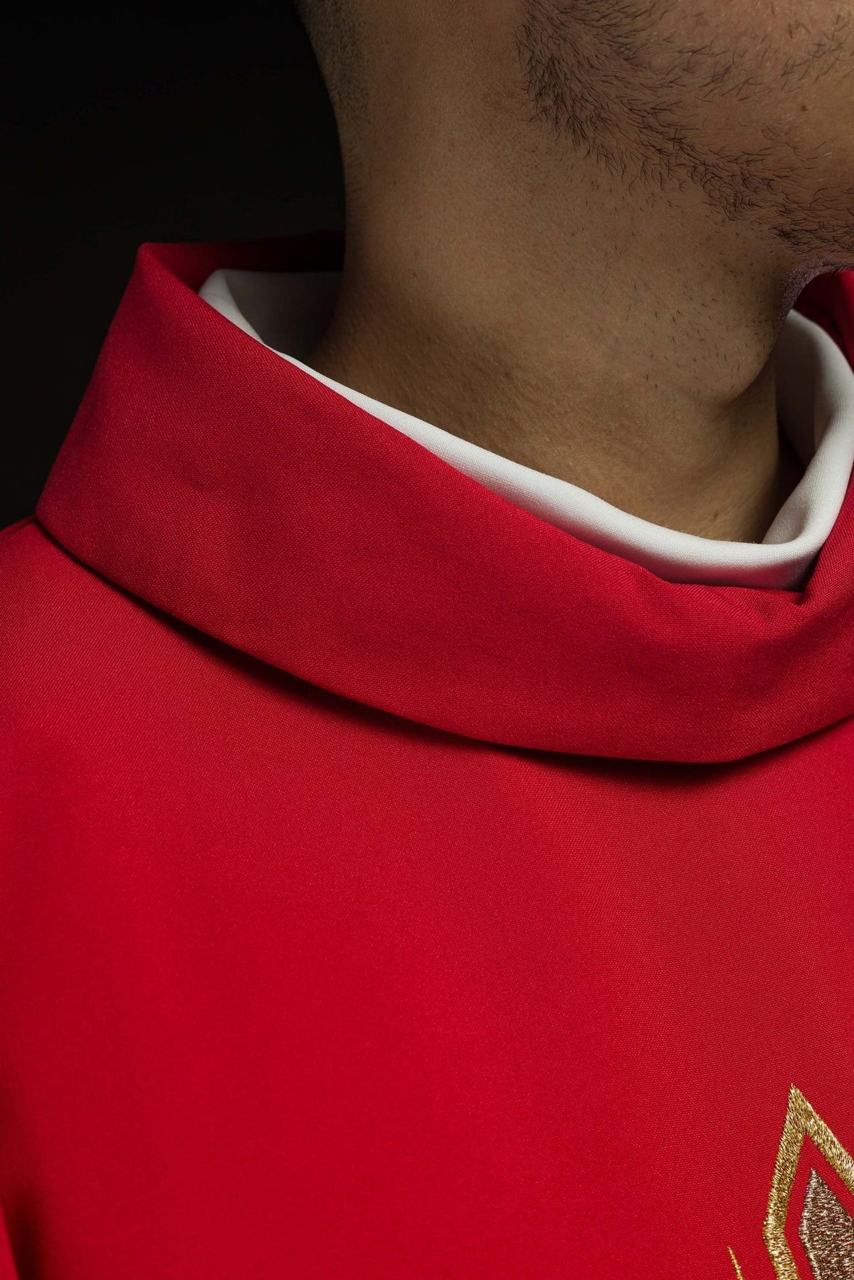 Red chasuble close-up showing red fabric and stand-up collar
