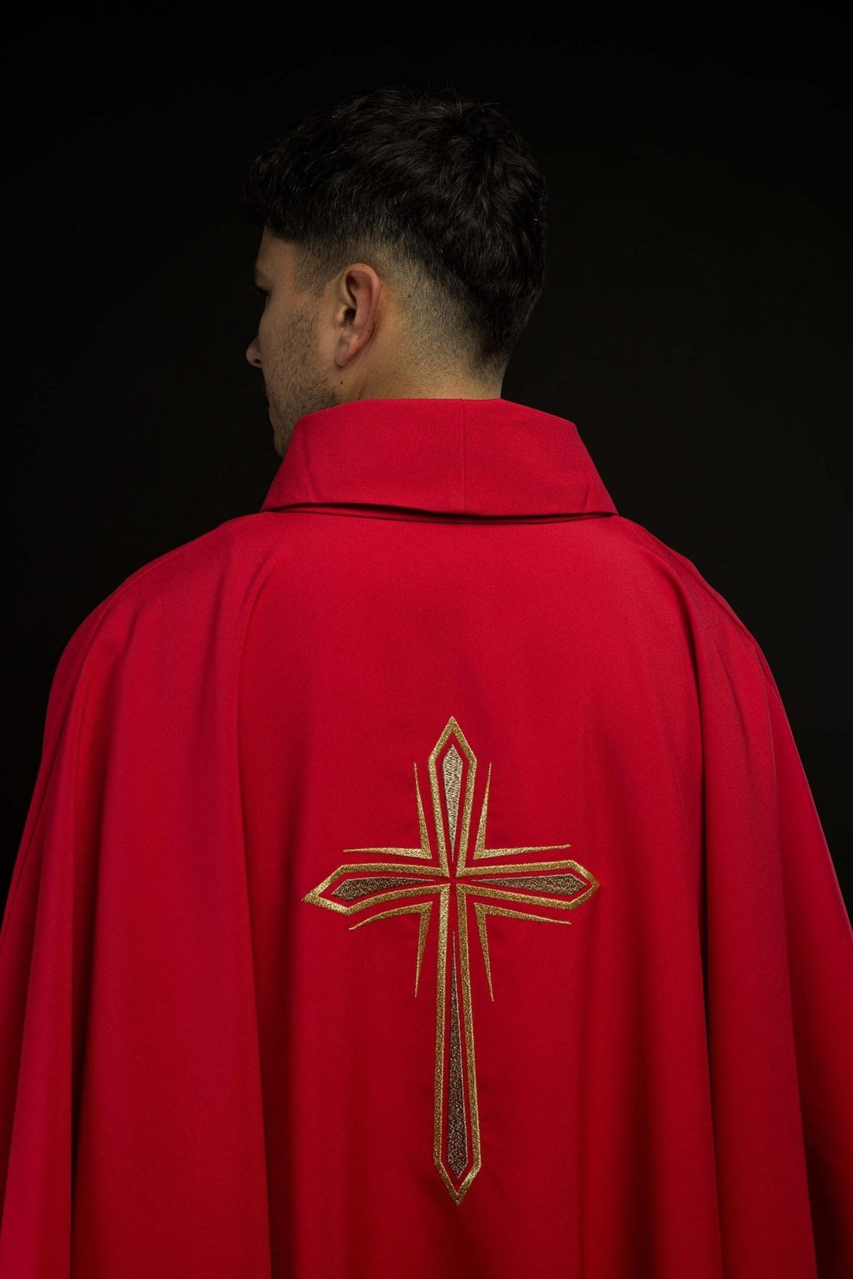 Red chasuble back view with gold embroidered cross and trim