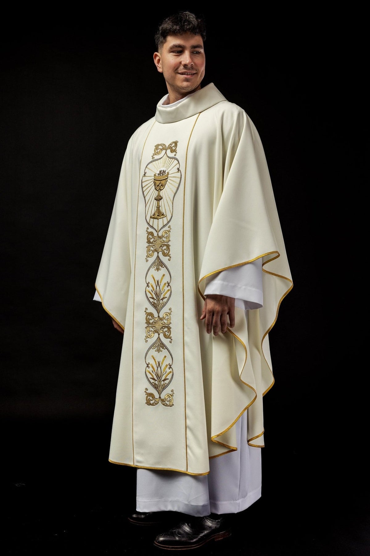 Ecru chasuble side view with gold trim and front embroidery