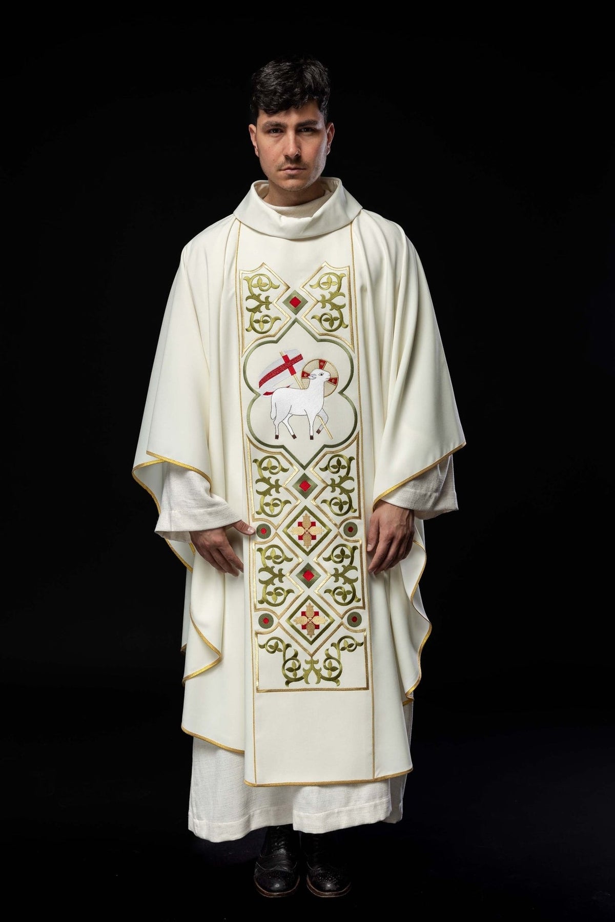 Ecru chasuble worn full length, showing front Agnus Dei embroidery and gold trim