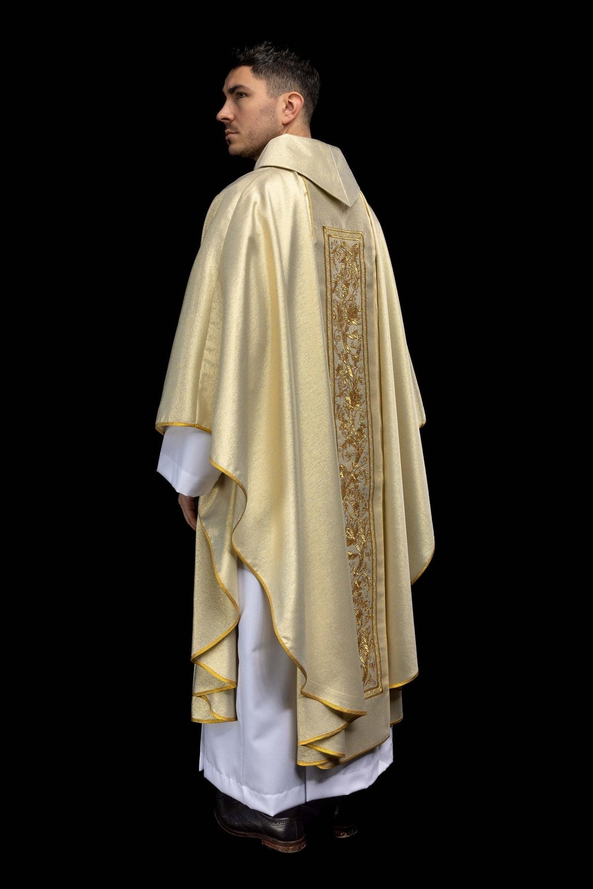 Gold chasuble side and back view with gold edging and embroidered orphrey
