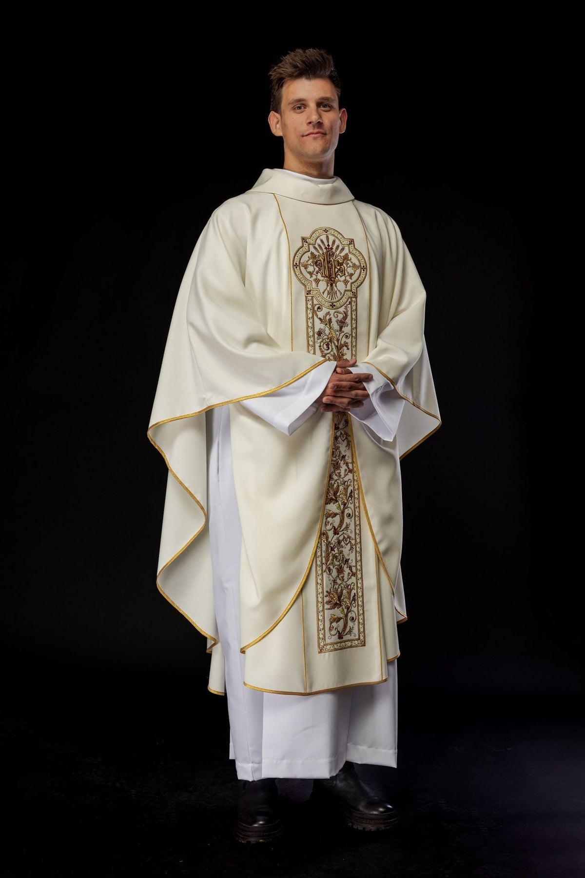 Ecru chasuble worn front, showing full embroidered IHS orphrey and gold trim
