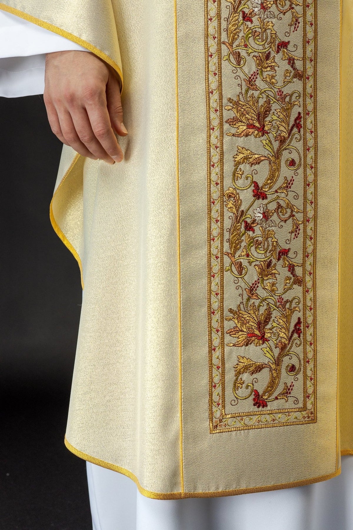 Gold chasuble detail showing embroidered floral orphrey and gold trim