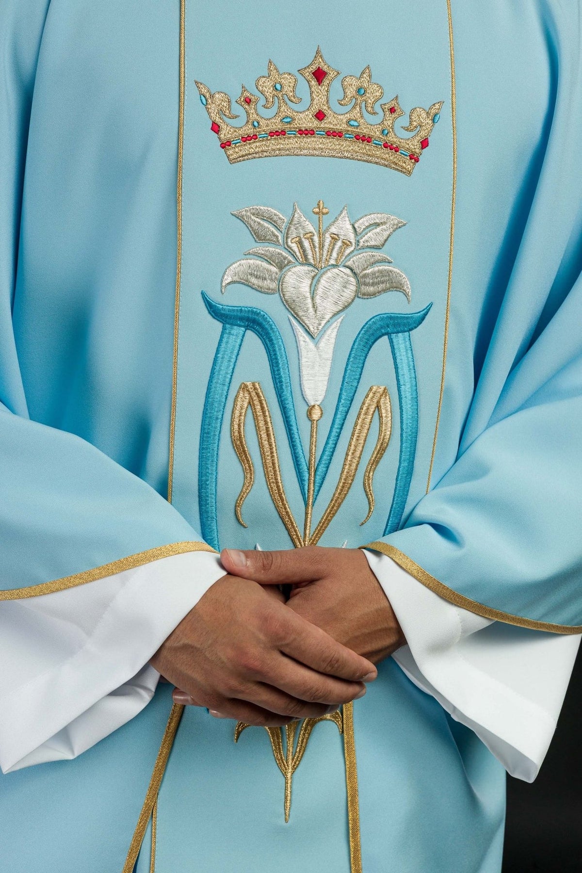 Blue Marian chasuble, close front view showing embroidered crown and Marian motif